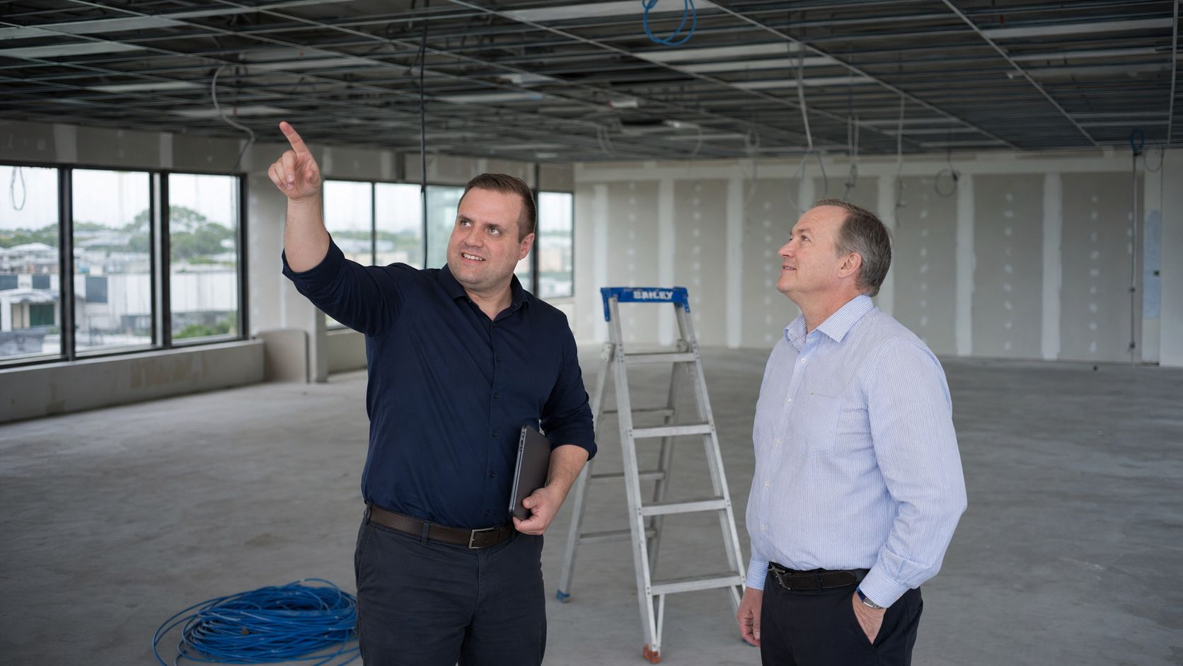 Brandon from Defy IT planning network cabling in an office fit-out