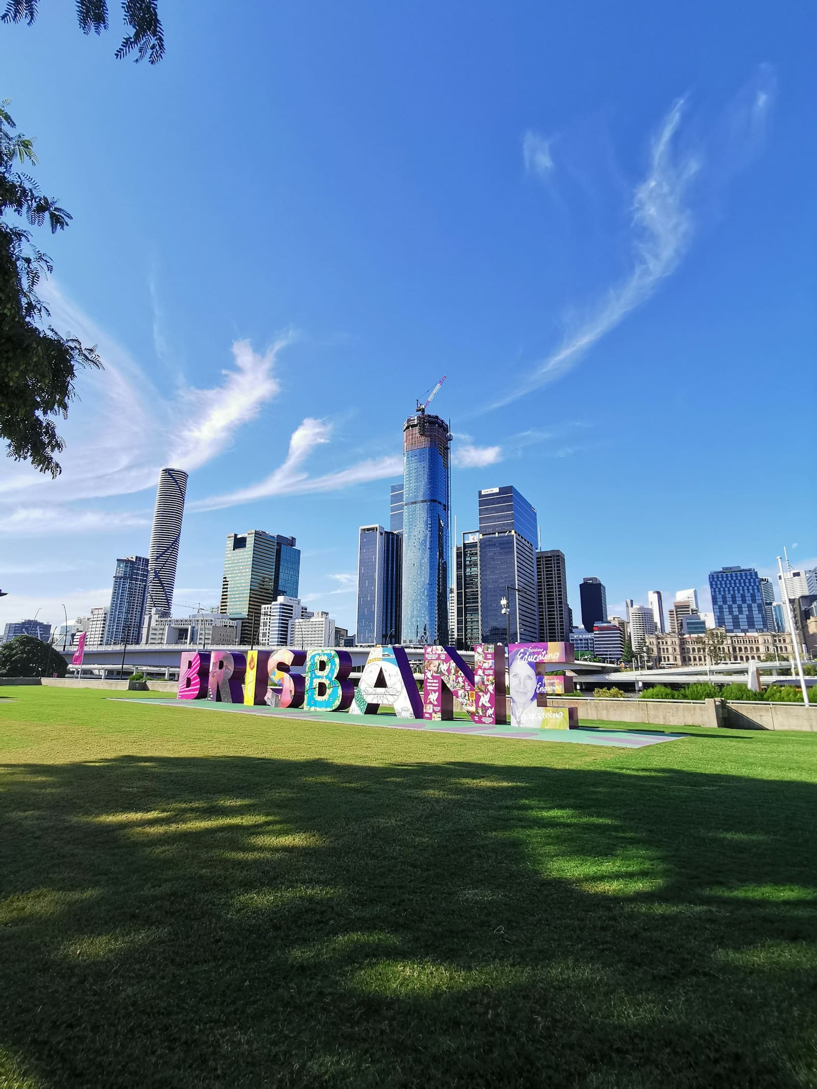 The Brisbane sign at South Bank with the city skyline behind it