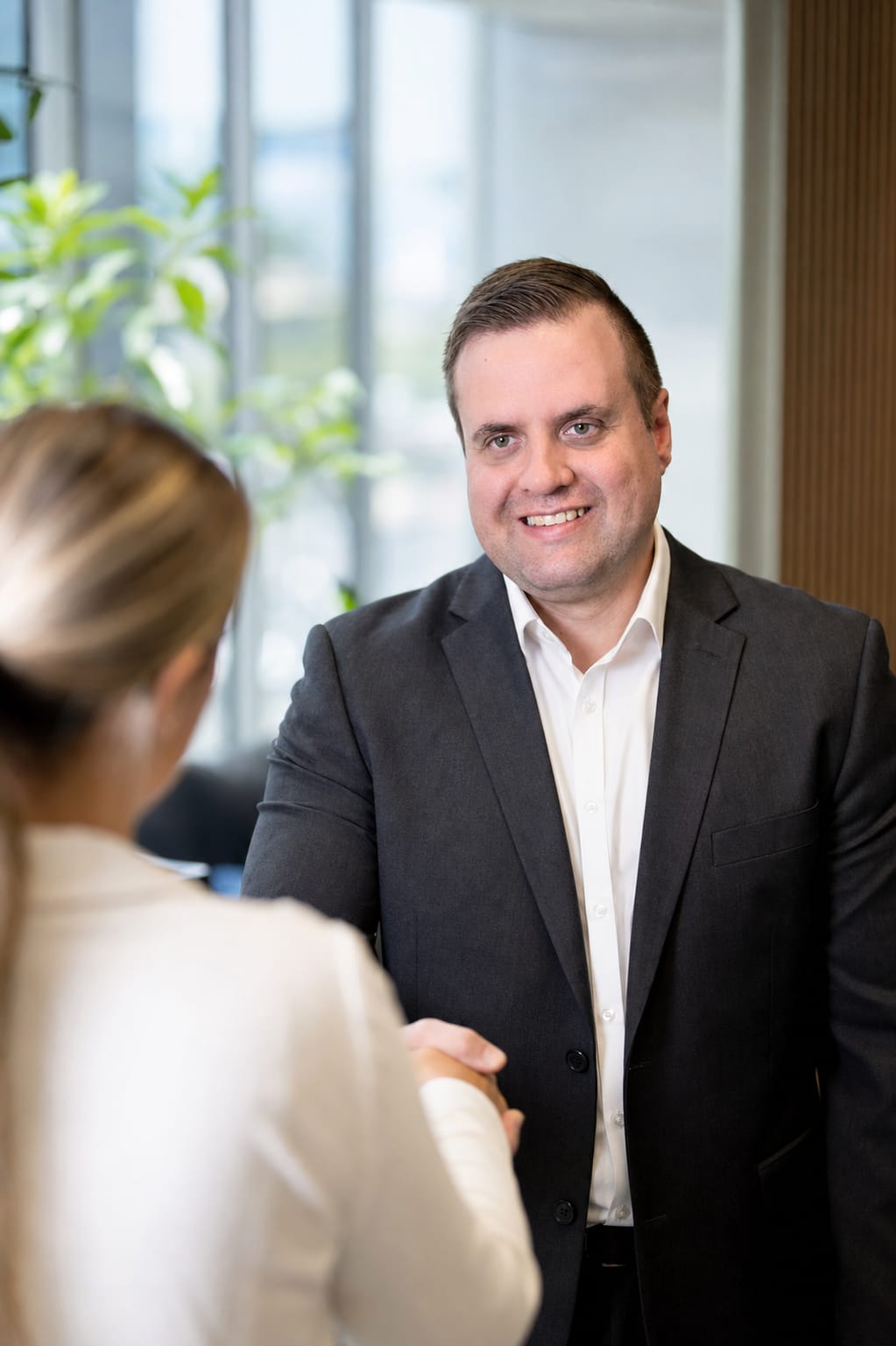 Brandon from Defy IT shaking hands with a client in an office